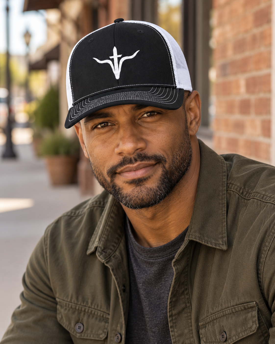LFD Signature Trucker Hat — Black / White, worn on a town sidewalk