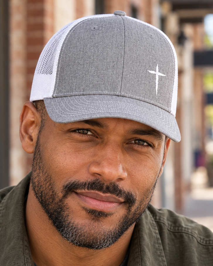Cross Trucker Hat — Heather Grey / White, worn on a town sidewalk, close view